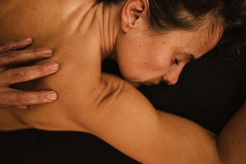 person topless woman covering her face arm
