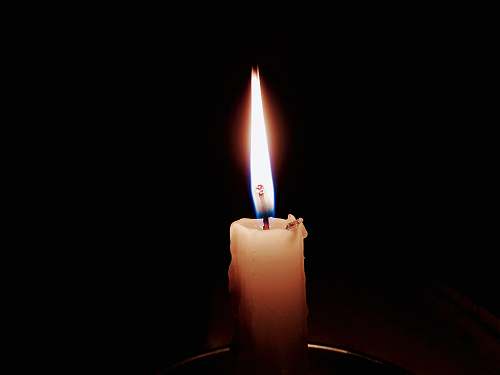 fire lit candle in focus photography flame
