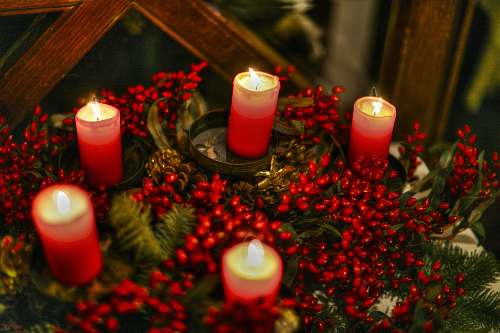 fire red candles on brown wooden table flame