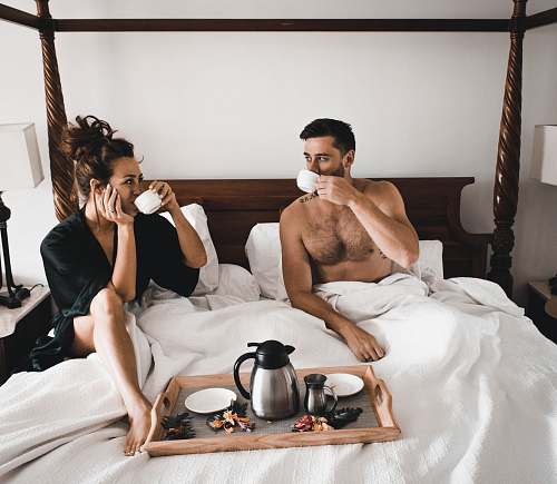  man drinking some coffee beside woman 