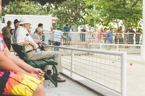 person people sitting on green bench people