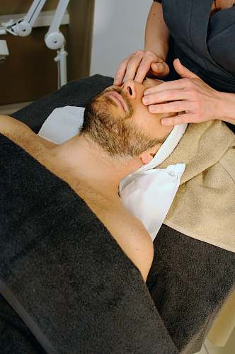 person sleeping man while having massage face