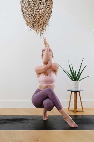 person woman in black panty kneeling on floor yoga mat