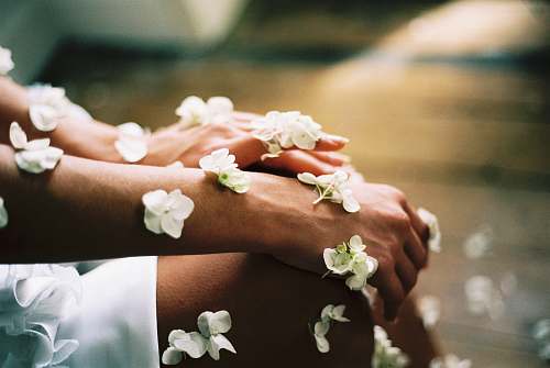 spa person surrounded by white flowers blossom