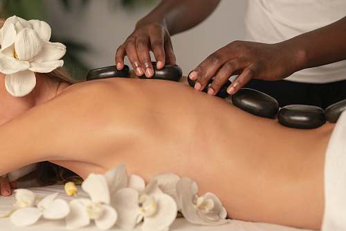human person holding white round ornament massage