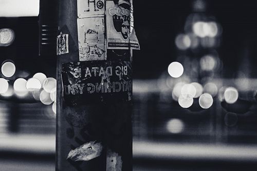 a pole with a bunch of stickers on it
