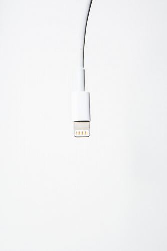 A white USB cord dangling from above.