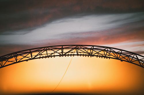 arch black truss during golden hour