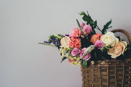 assorted-color flowers on brown wicker basket