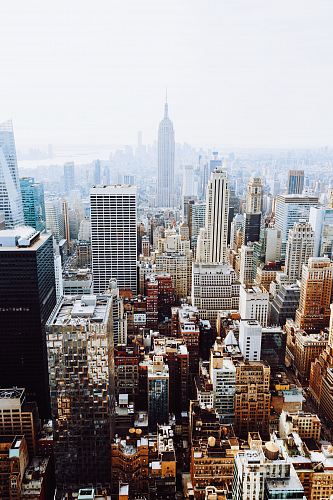 birds-eye view photo of city buildings with fog