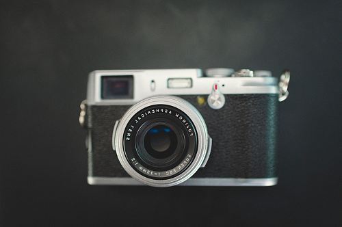 black and gray MILC camera on top of black surface