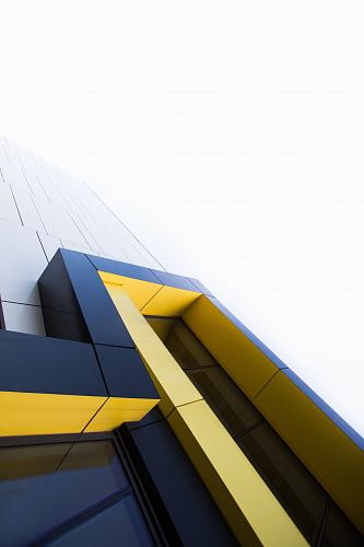 black and yellow building under white clouds