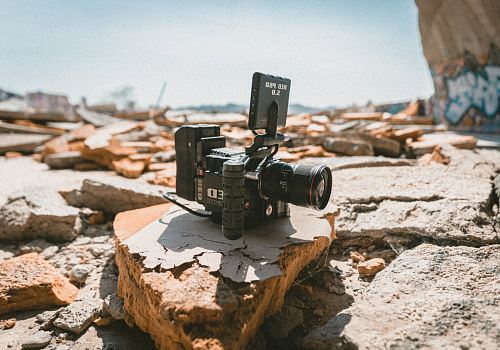black camera on gray and brown stone