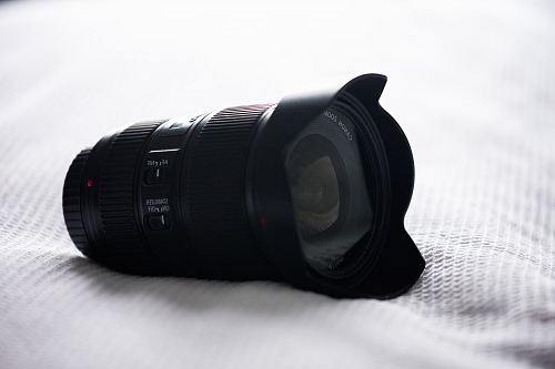 black camera zoom lens on white top textile