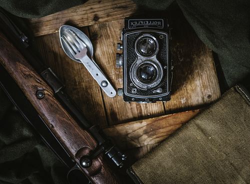black land camera beside spoon and fork