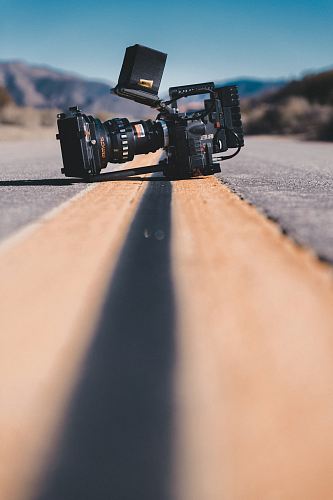 black shoulder-held camcorder on road