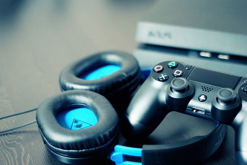 black Sony PS4 controller and black Turtle Beach headphones