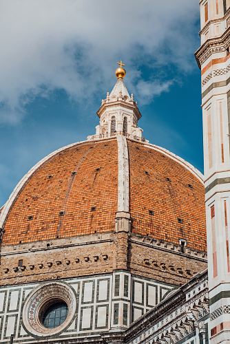 brown, white, and orange bricked cathedral