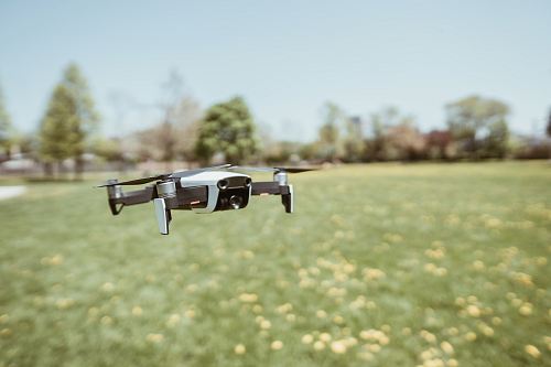 flying white and black drone