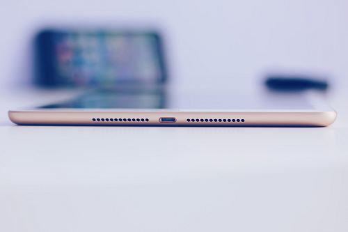 gold iPad mini on white surface