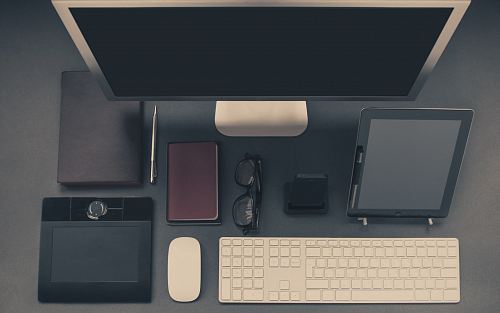 gray computer set with tablet and eyeglasses