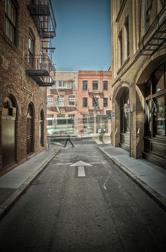 gray concrete road and brown buildings during daytime
