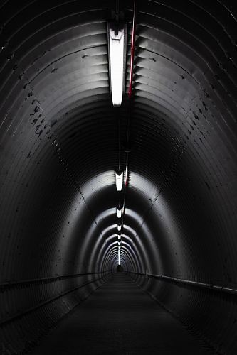 gray concrete tunnel with light