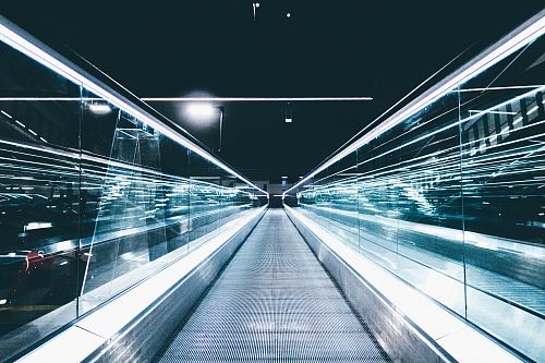gray conveyor between glass frames at nighttime