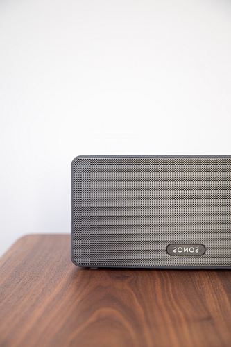 gray Sonos speaker on table