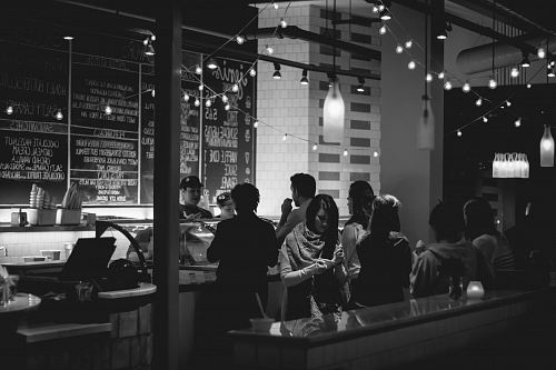 grayscale photography of people standing in line