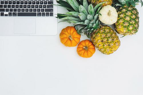 green pineapple fruit near MacBook