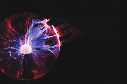 human hand holding plasma ball