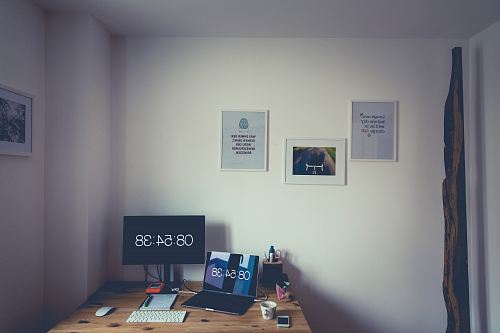 laptop computer near the monitor with time at 08:54:38