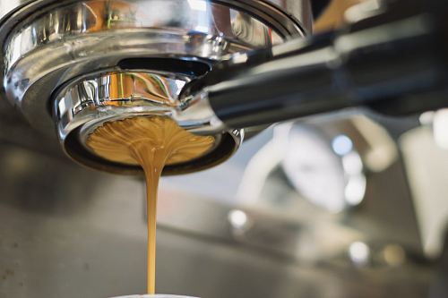 Latte dripping from a coffee machine