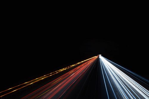low exposure photo of cars on road during night time