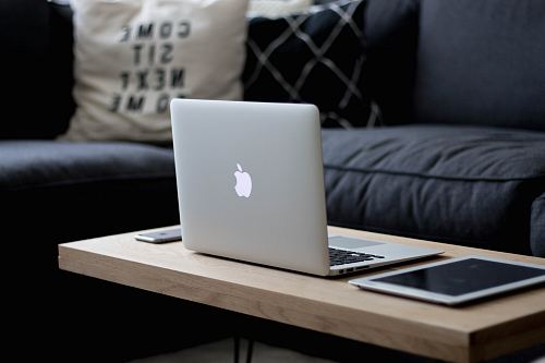 MacBook Air on brown wooden center table