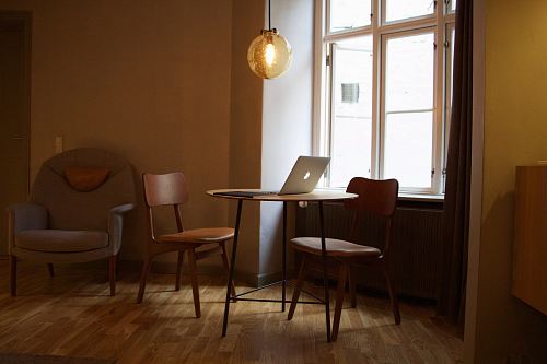 MacBook on table near window