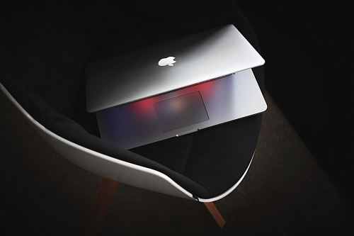 MacBook Pro on black padded chair