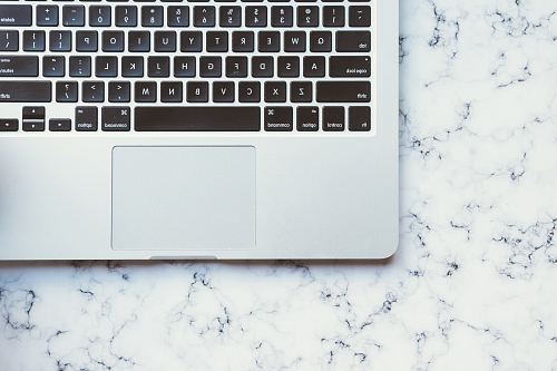 MacBook Pro on white marble surface