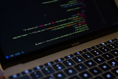 MacBook Pro with images of computer language codes