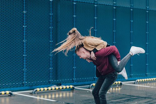 man carrying woman on back