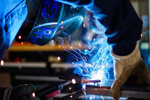 man holding gray steel frame