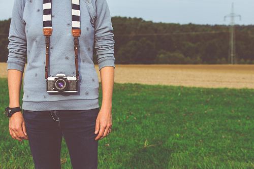 man standing with black camera