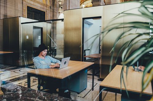 man using a gray laptop computer
