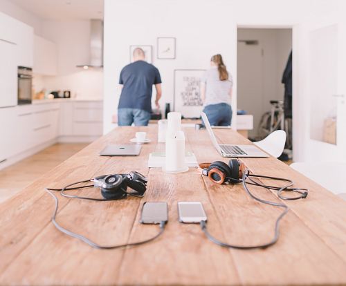 orange and black headphones on table