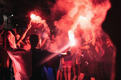 people holding firecrackers at night