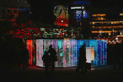 people standing near colorful wall