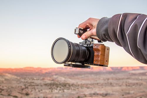 person holding black DSLR camera