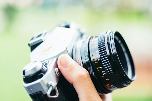 person holding black DSLR camera