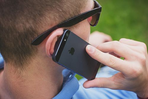 person holding black iPhone 5s